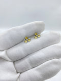 Three-petal flower design in radiant yellow, centered with a luminous white stone earring