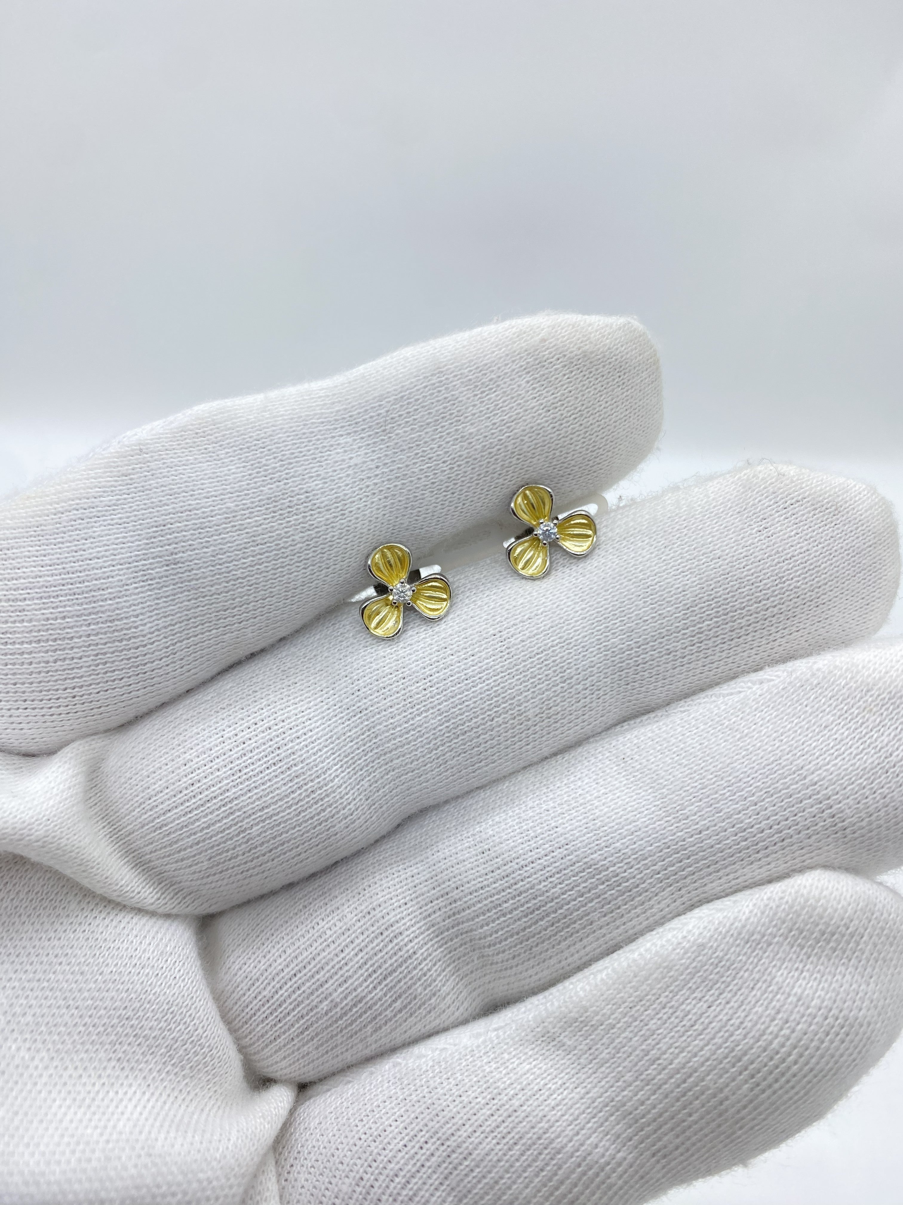 Three-petal flower design in radiant yellow, centered with a luminous white stone earring