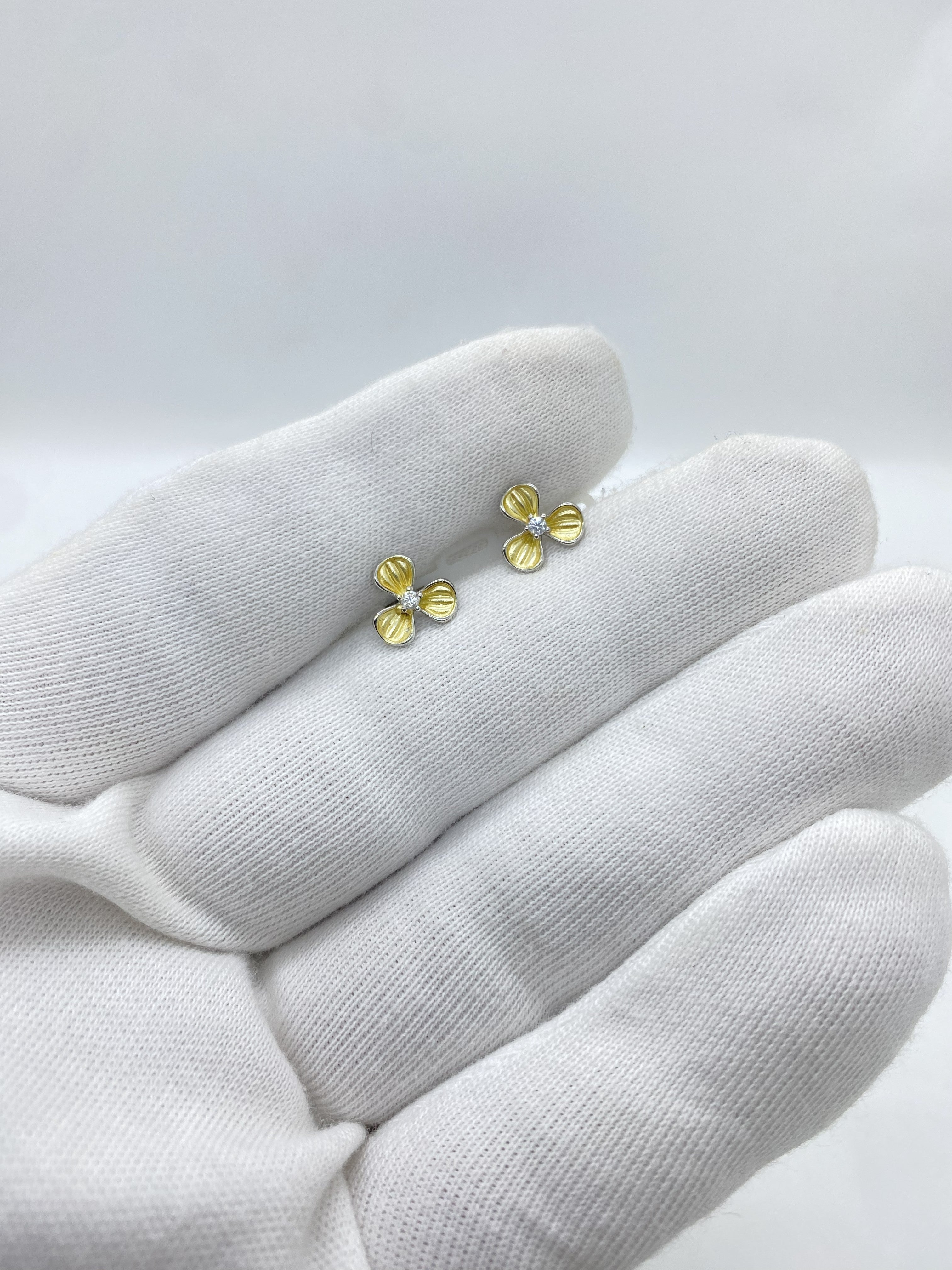 Three-petal flower design in radiant yellow, centered with a luminous white stone earring