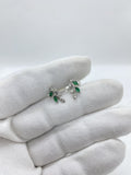 silver earrings featuring vibrant green gemstones