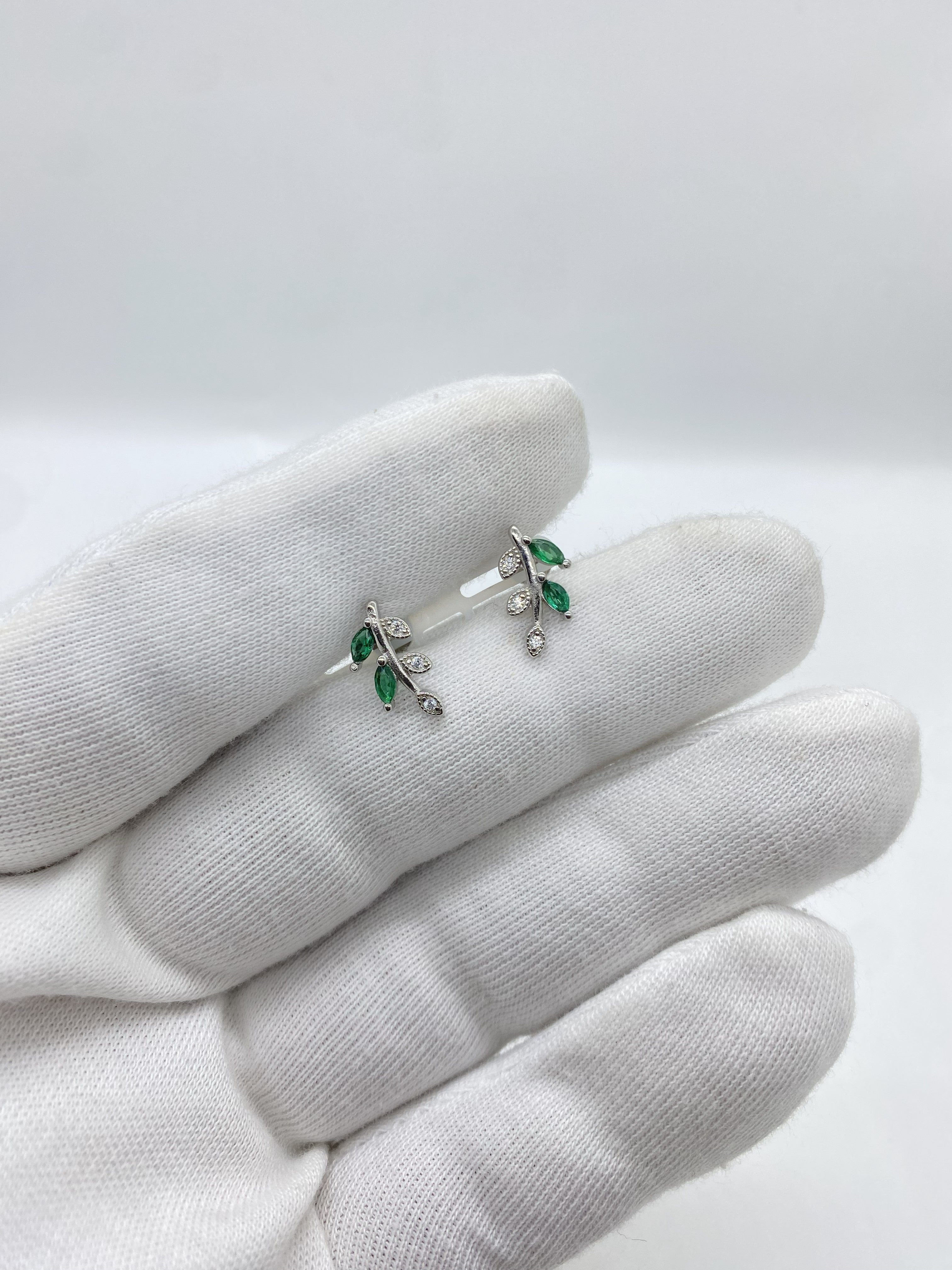 silver earrings featuring vibrant green gemstones